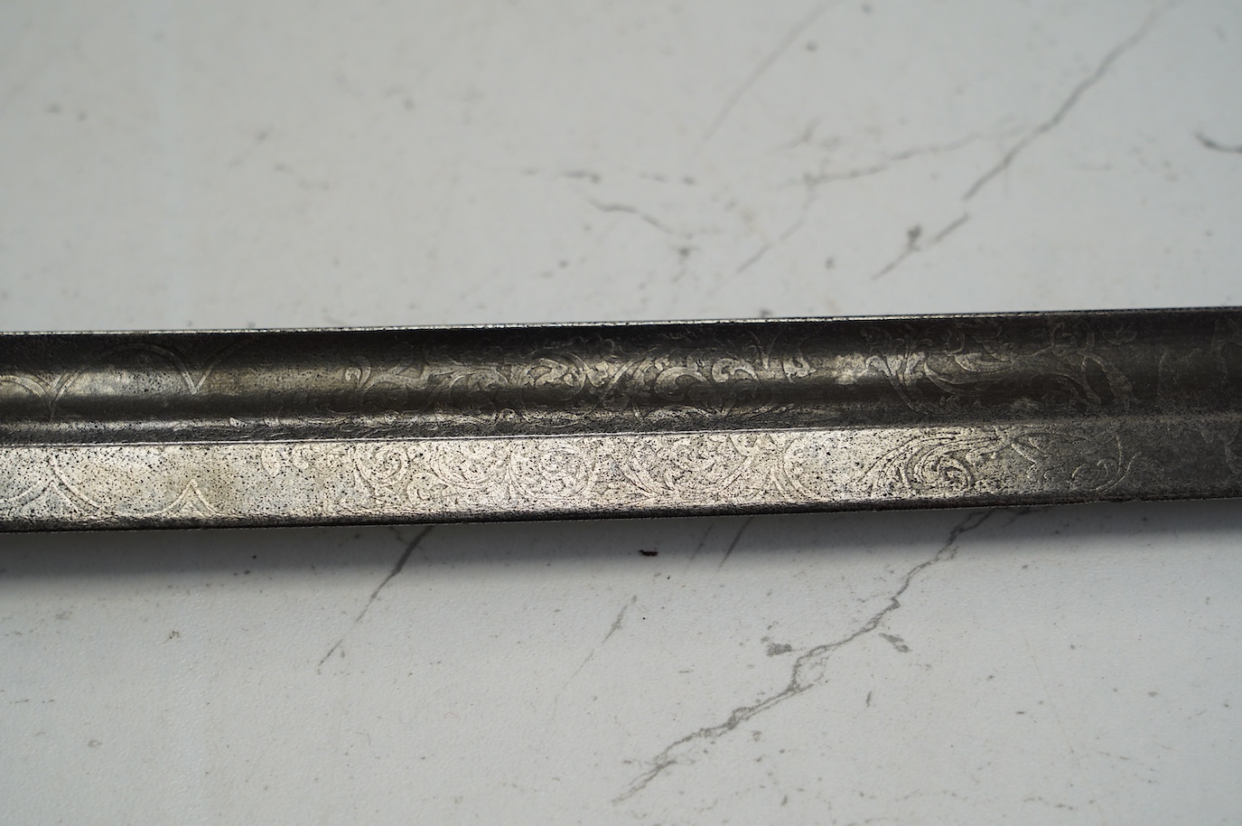 An 1845 infantry officer’s sword, with engraved, fullered and proofed blade, brass guard and remains of shagreen grip, blade 80.5cm. Condition - fair, well worn
